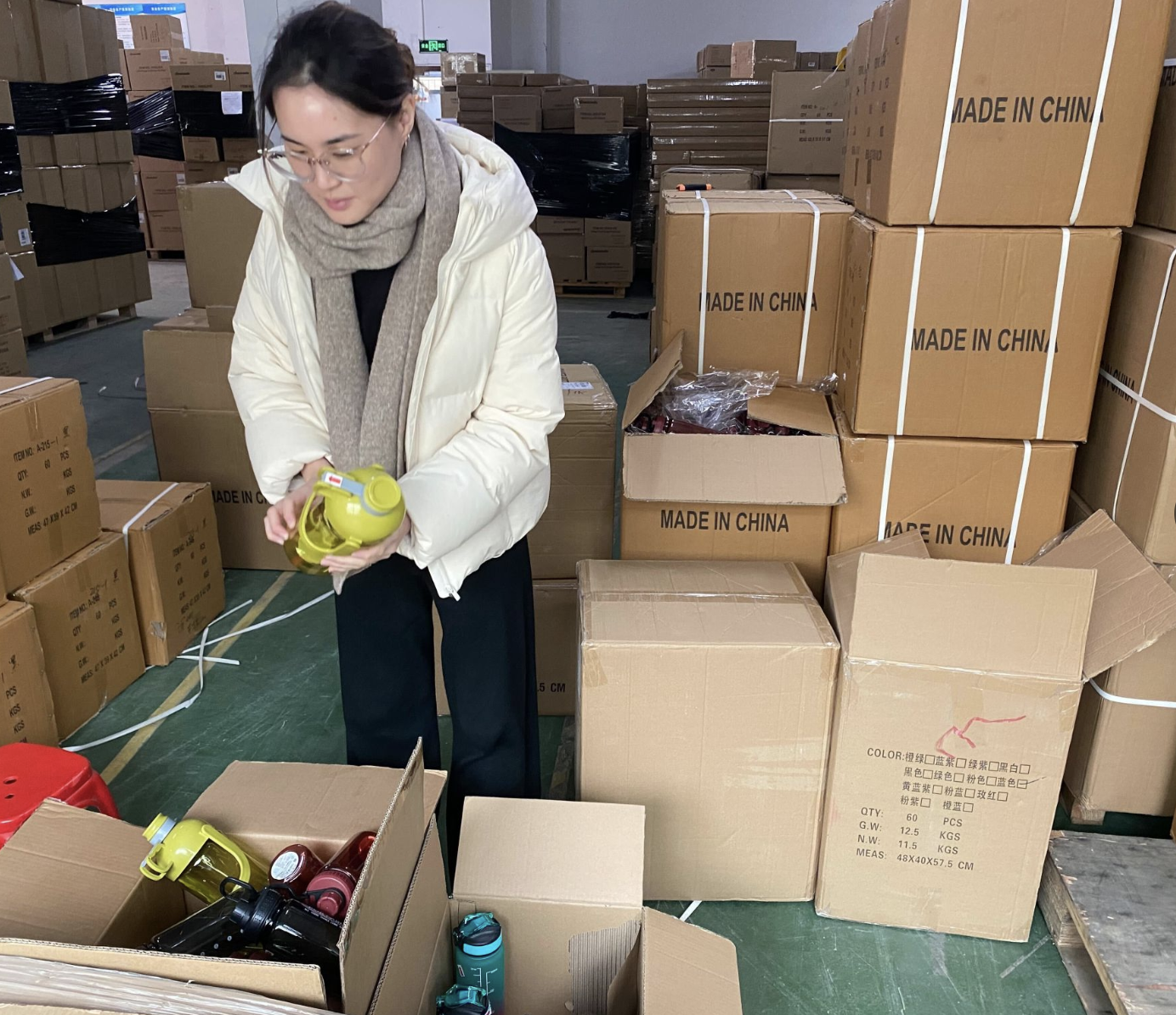Sourcy team member inspecting product samples at factory warehouse